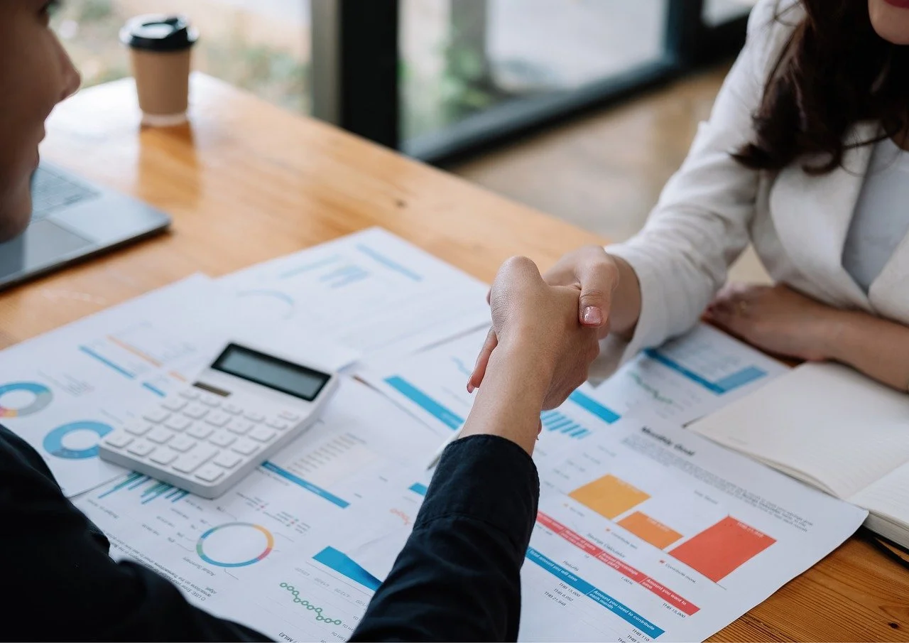 An abstract representation of a luminous achievement. A series of intersecting, polished metallic planes (dark chrome, obsidian black, brushed aluminum) converging to form a dynamic, faceted structure. From its core, a brilliant electric cyan light emanates, casting subtle glows and reflections. The background is a deep, blurred void, emphasizing the central form. The image conveys prestige, sharp excellence, and undeniable impact through light and shadow.